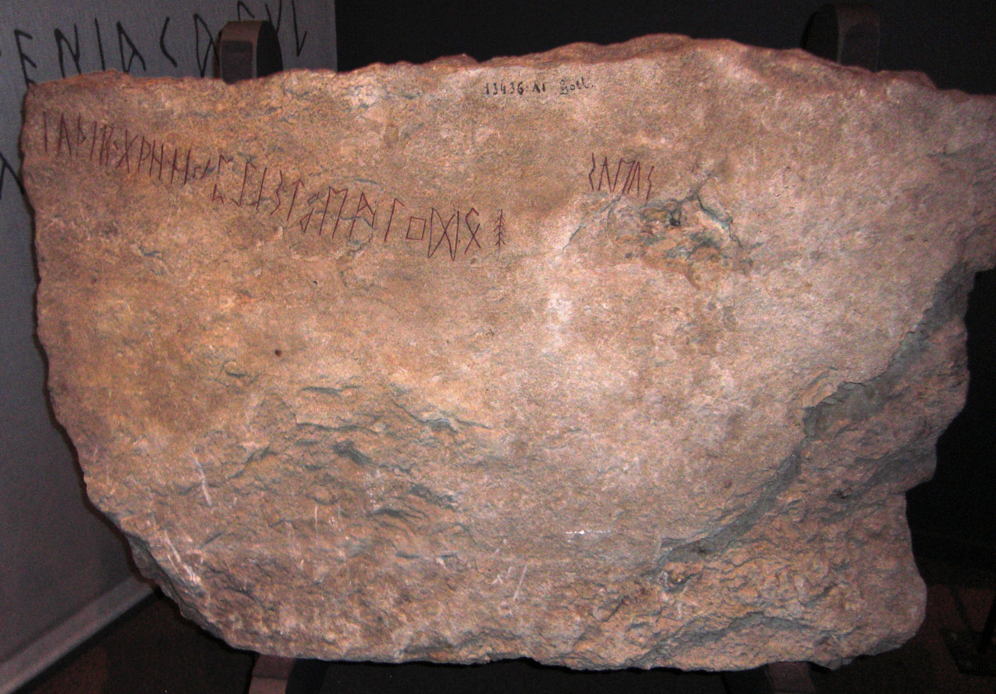 Photograph of the Kylver runestone showing the complete Elder Futhark runic alphabet carved in limestone