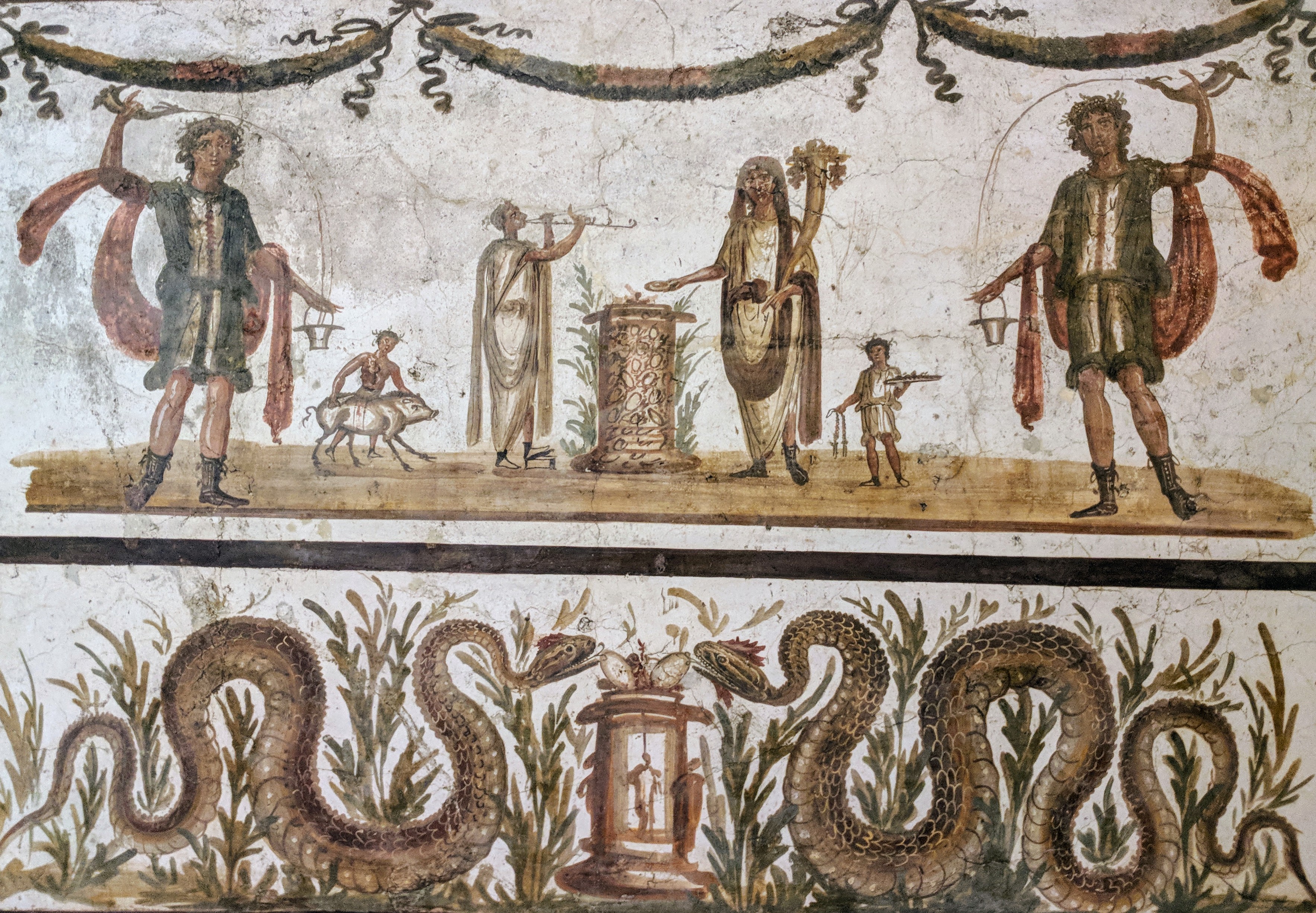 Roman fresco showing two dancing Lares spirits flanking a sacrifice scene, with serpents below