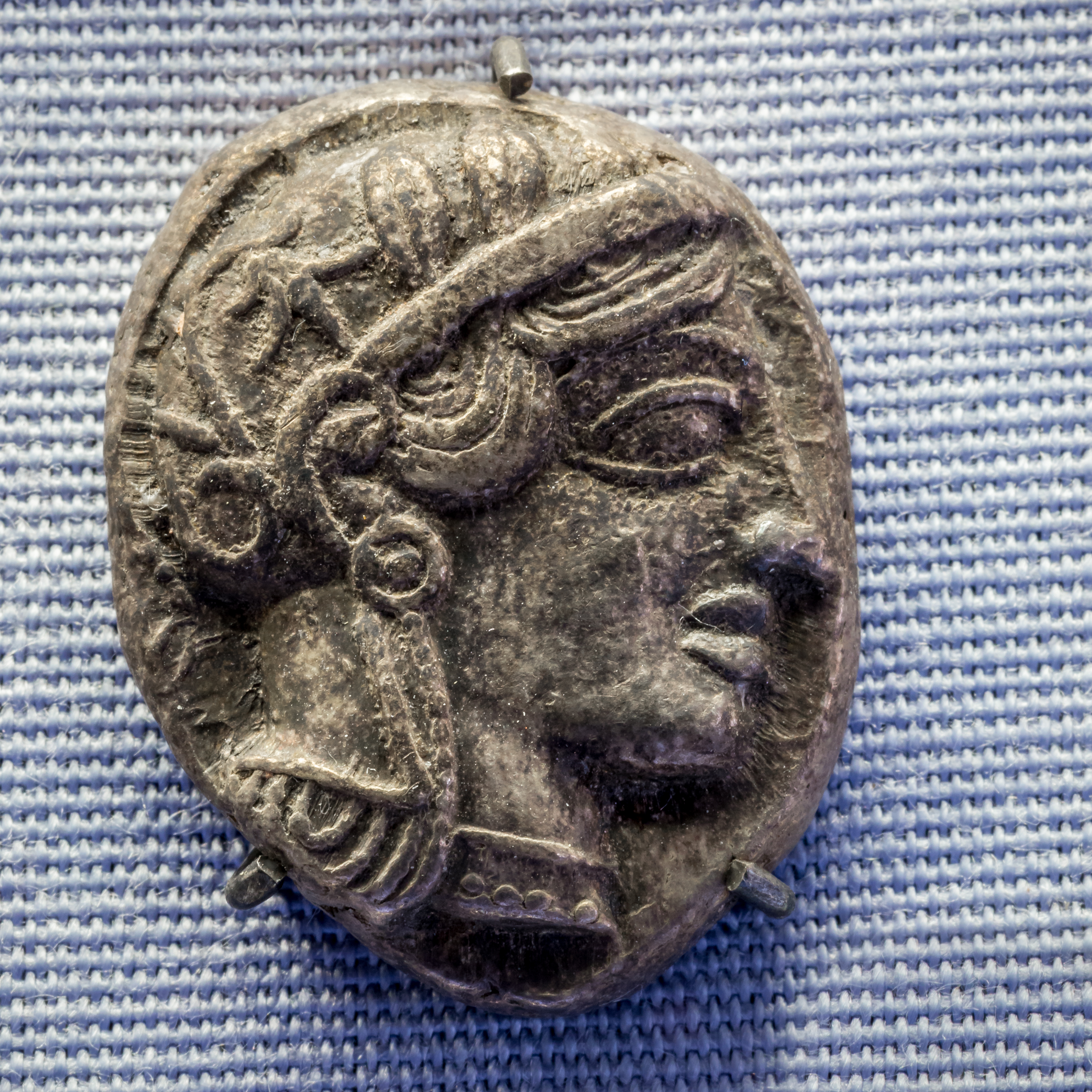 Silver coin showing an owl, the symbol of Athena-Minerva